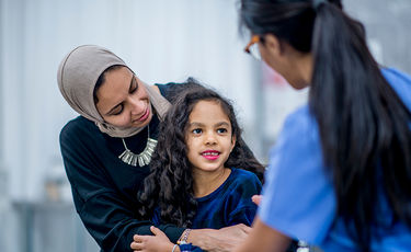 Mother comforting daughter at checkup