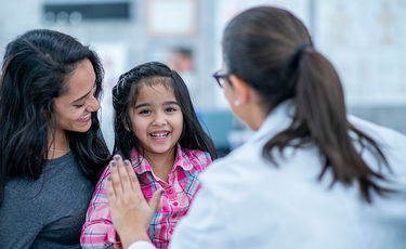 Mother and child with doctor giving high-five